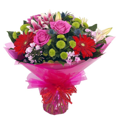 Country Garden - Hand tied bouquet in tones of red, pink and green. Including pretty roses, vibrant gerberas and stylish lilies. Beautifully presented gift wrapped in water.