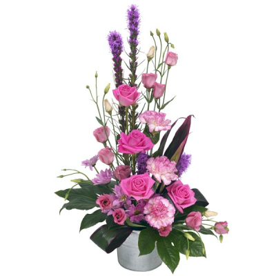 Pretty in pink - Flower arrangement in tones of pink in a container.