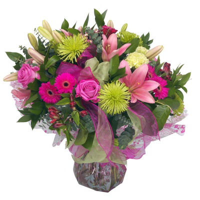 Citrus Twist - Hand tied bouquet in pink and green. Including beautiful roses, pretty gerberas and stylish lilies. An impressive hand tied bouquet.