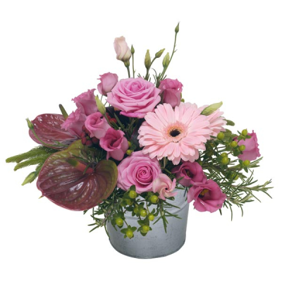 Cherished Moment - Flower arrangement in pretty pink tones in a container. An all round design, perfect for table centre. Including beautiful roses, pretty gerberas and seasonal pink flowers.